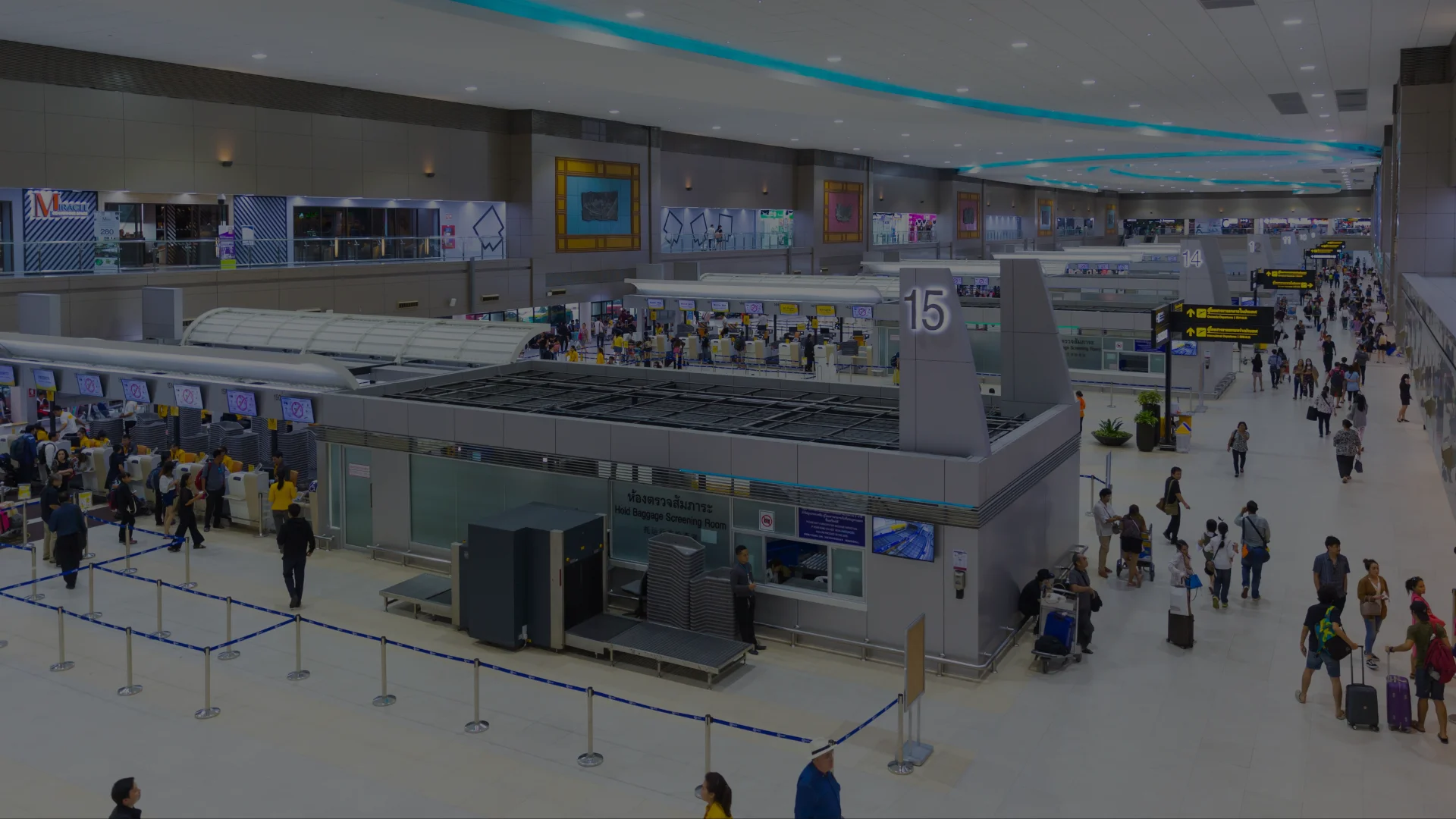Passenger dropping a suitcase at the 24-hour luggage storage counter in Suvarnabhumi Airport's Airport Rail Link zone
