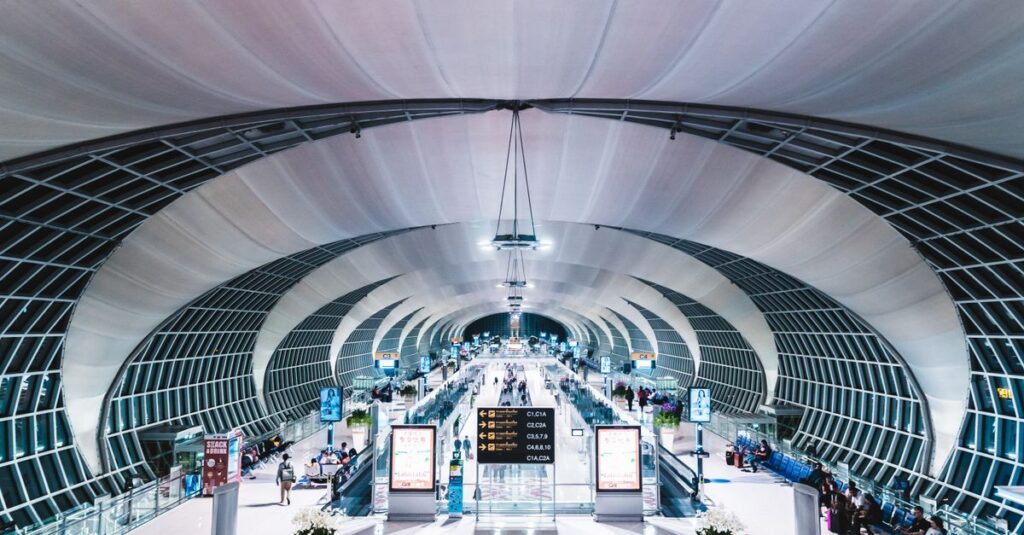 Alt: Traveler with a daypack heads to the Airport Rail Link at Suvarnabhumi during a 6-hour Bangkok transit stop