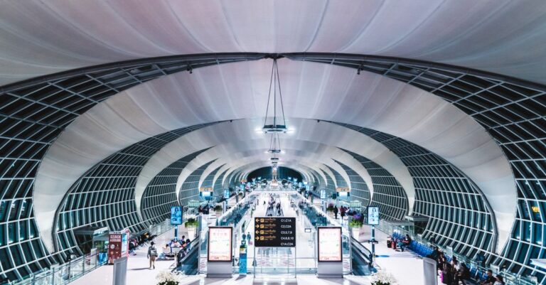 Alt: Traveler with a daypack heads to the Airport Rail Link at Suvarnabhumi during a 6-hour Bangkok transit stop
