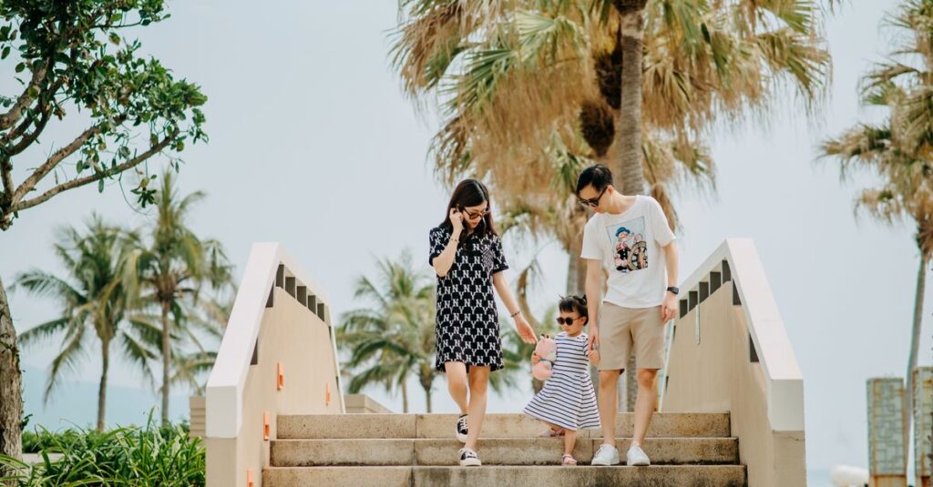Alt: Parents leaving a Bangkok hotel hands-free with only a stroller and a daypack after sending their luggage ahead