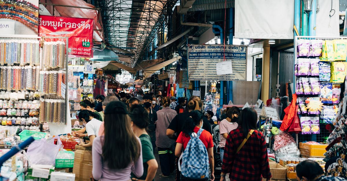 Shoppers browsing stalls at Chatuchak Weekend Market Bangkok