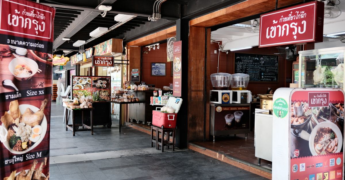 Thai street food stall with traditional dishes at a Bangkok market