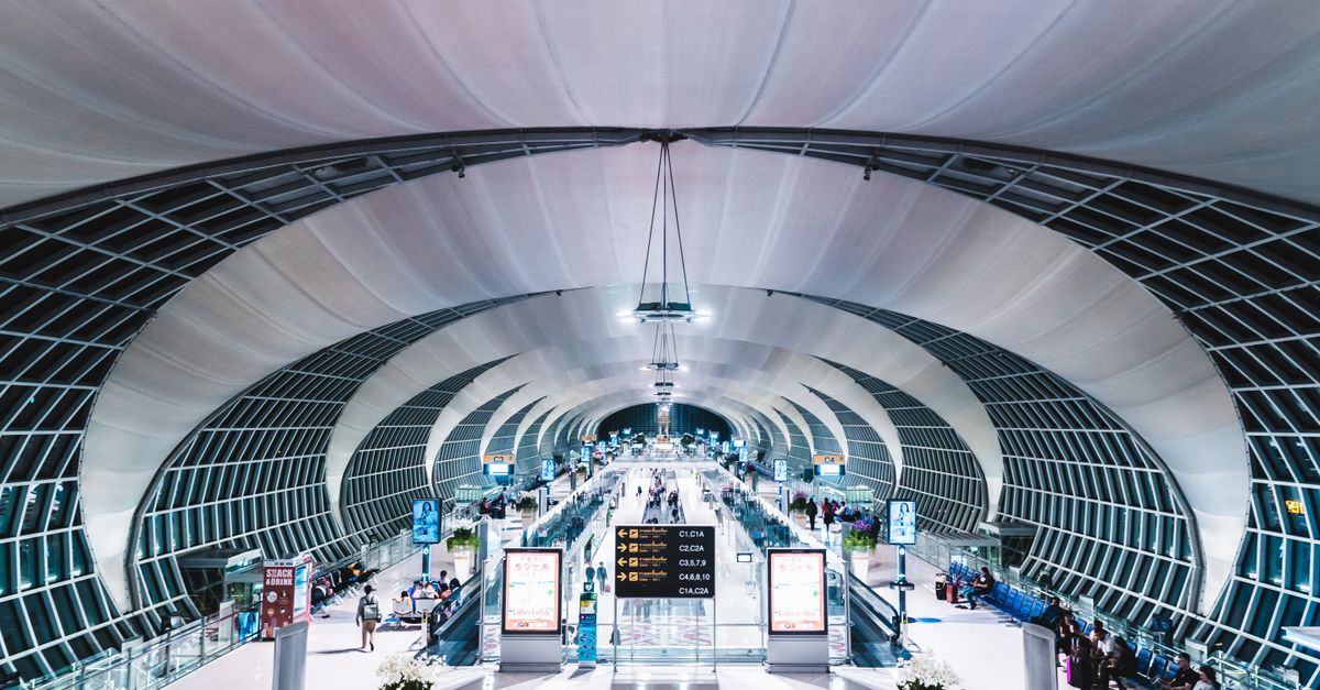 The departures hall at Suvarnabhumi Airport, where both AIRPORTELs and Bellugg operate counters inside the terminal