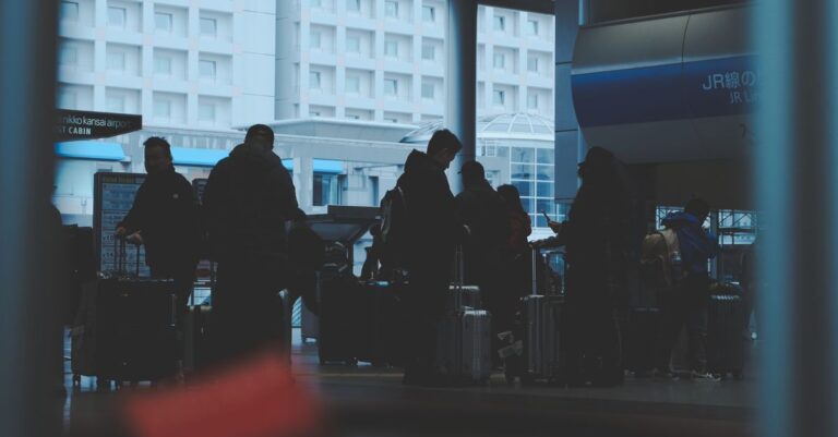 Travelers with luggage in a Japanese railway station - the takuhaibin travel style