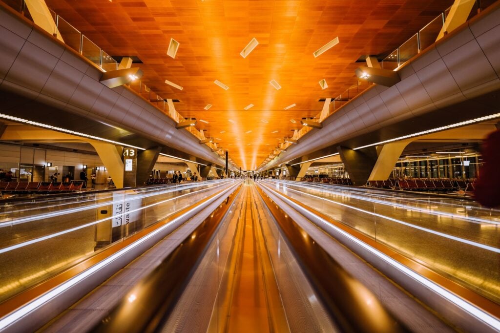 Moving walkway in a modern airport terminal, photographed as a long exposure