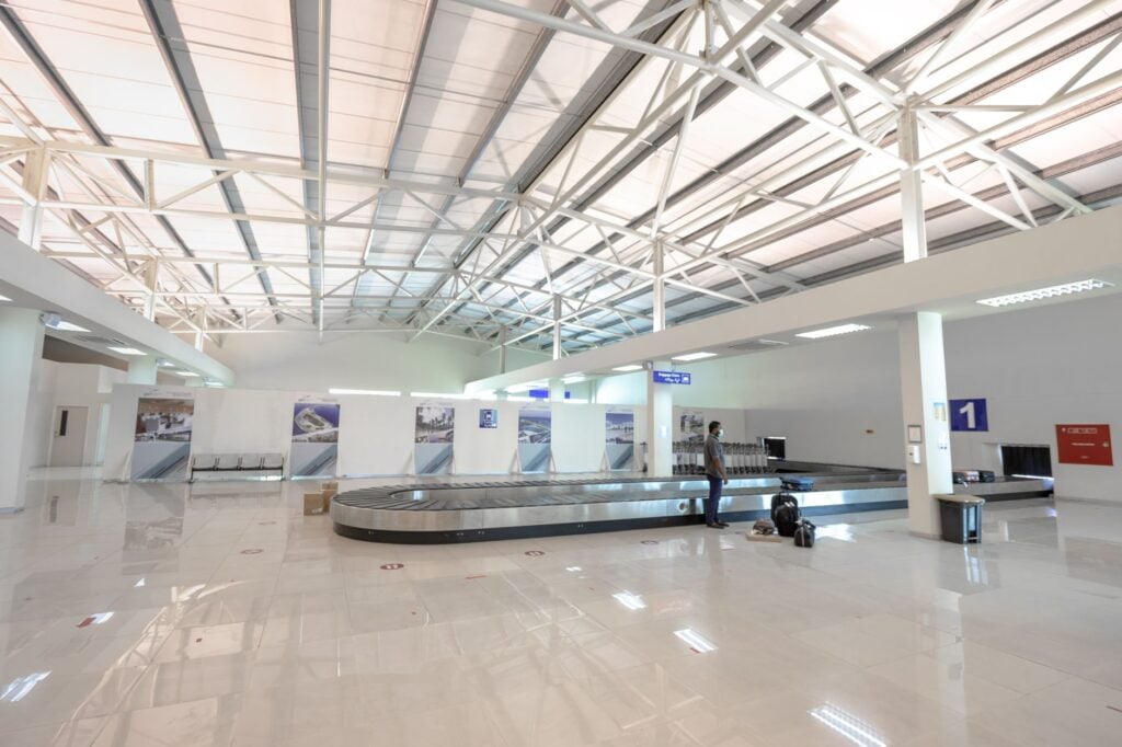 Empty airport baggage claim hall with the carousel at rest