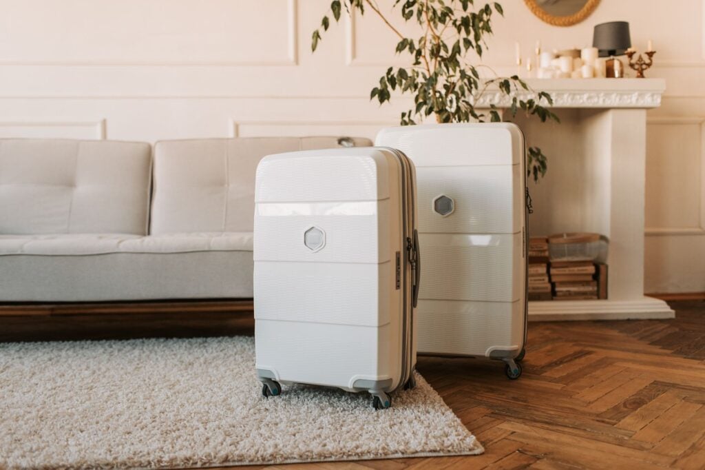 Two hard-shell suitcases standing packed and ready
