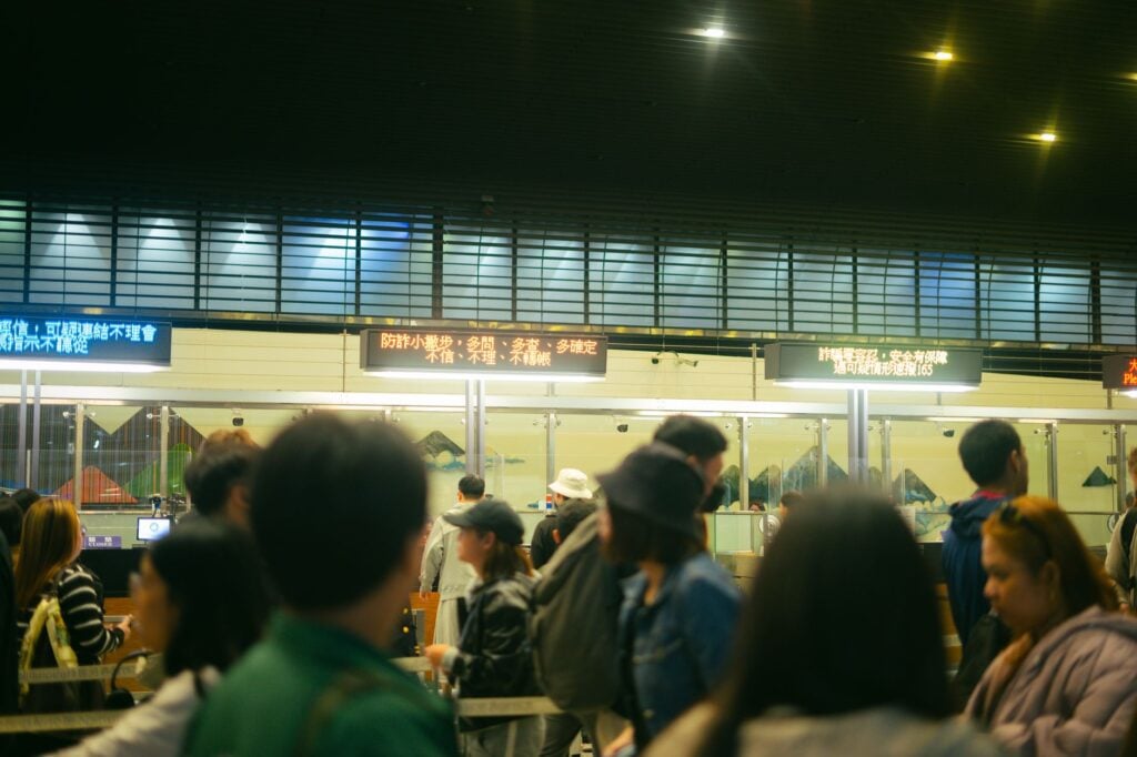 Airport check-in counters with passengers waiting to drop bags