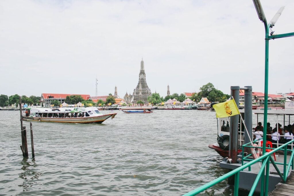 River boats on the Chao Phraya with Wat Arun on the far bank