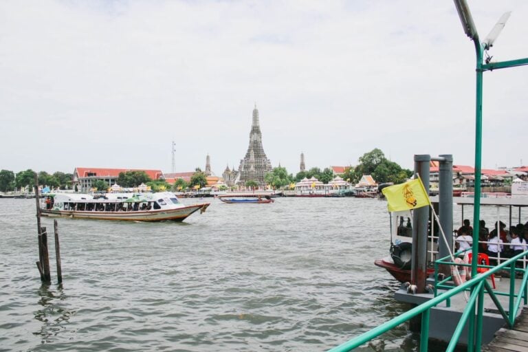 River boats on the Chao Phraya with Wat Arun on the far bank