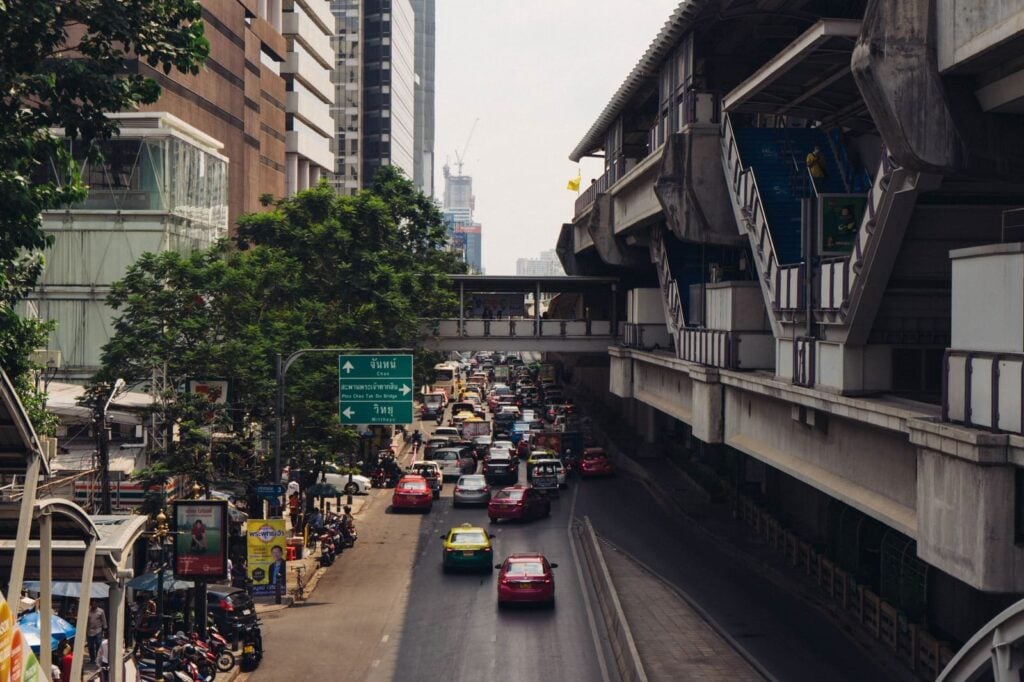 Traffic on a Bangkok avenue running beside the elevated BTS Skytrain line